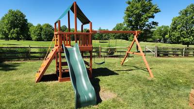 wooden playset with swings and slide